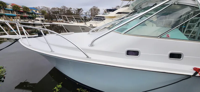 Re-fit 2021-2024 With 2017 Cummins 540s Yacht Photos Pics 1995 Cabo 35 Express boat docked at marina, side view.