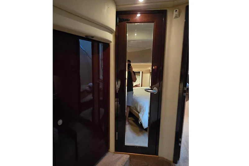  Yacht Photos Pics Interior view of 2008 Sea Ray 58 Sedan Bridge yacht bedroom with mirrored door.