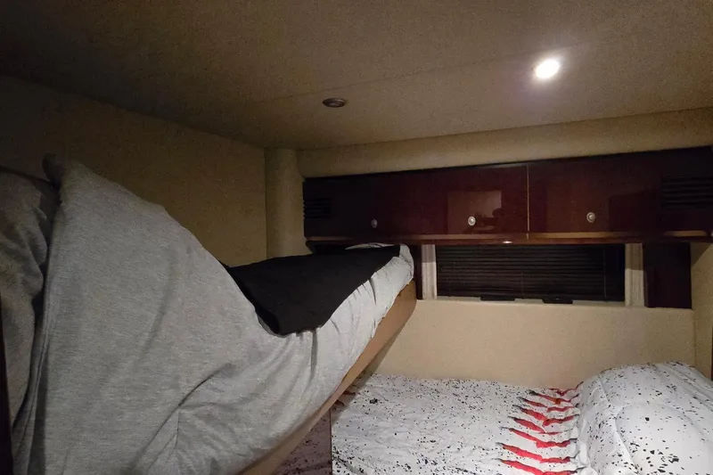  Yacht Photos Pics Interior cabin of 2008 Sea Ray 58 Sedan Bridge with bunk beds and storage cabinets.