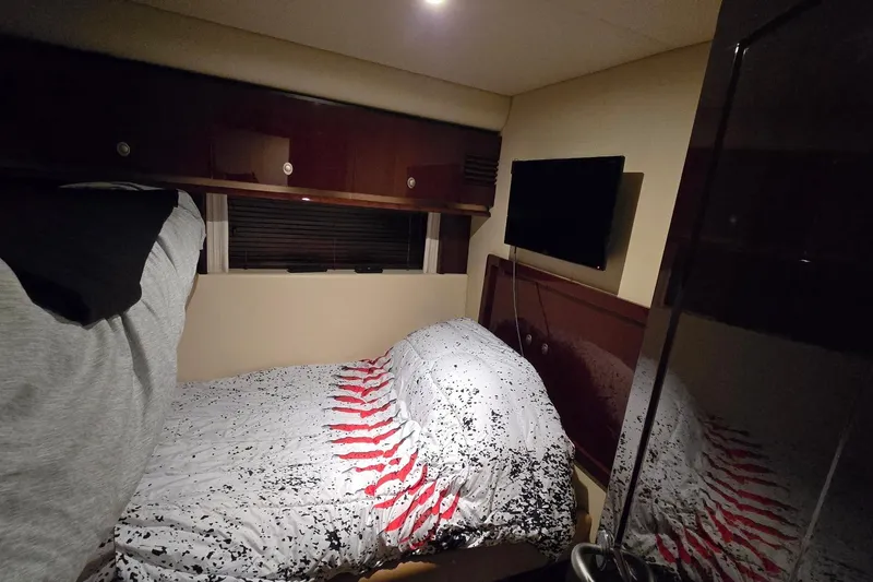  Yacht Photos Pics Cabin interior of 2008 Sea Ray 58 Sedan Bridge with bed and wall-mounted TV.