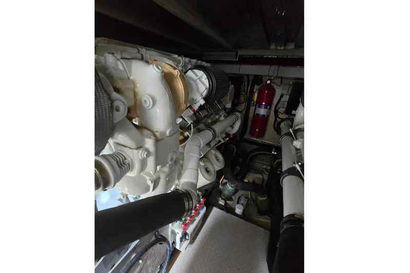  Yacht Photos Pics Engine room of 2008 Sea Ray 58 Sedan Bridge, showcasing mechanical components and fire extinguisher.