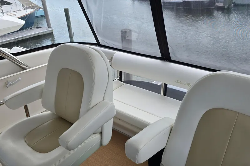  Yacht Photos Pics 2008 Sea Ray 58 Sedan Bridge interior with white leather seating, overlooking marina.