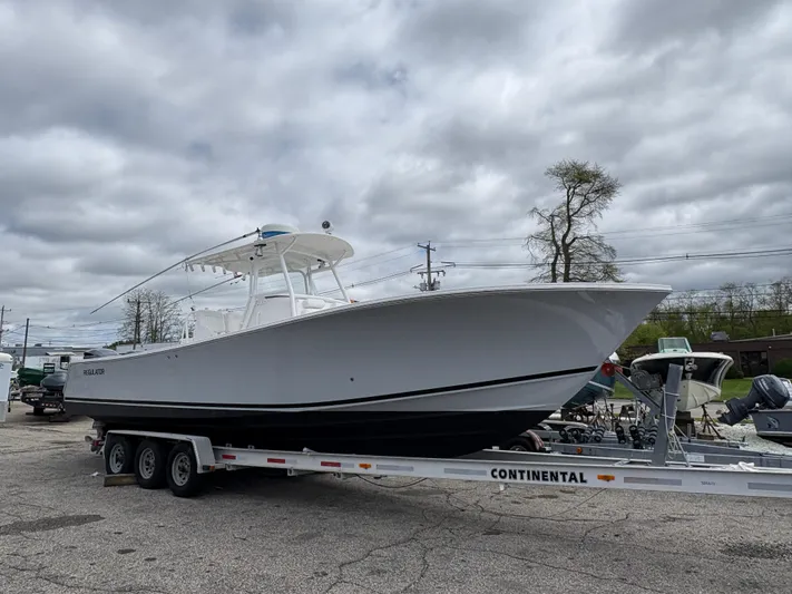  Yacht Photos Pics 2009 Regulator 32 Forward Seating boat on a Continental trailer, parked outdoors.