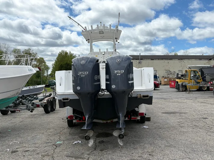  Yacht Photos Pics 2009 Regulator 32 Forward Seating boat with twin 350 HP engines, parked outdoors.