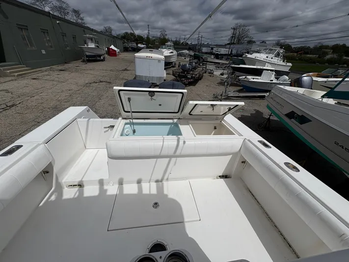  Yacht Photos Pics 2009 Regulator 32 Forward Seating boat with open storage compartments, docked in a marina.