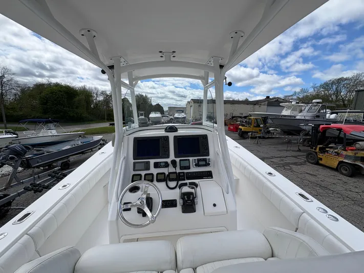  Yacht Photos Pics 2009 Regulator 32 Forward Seating boat cockpit with steering wheel and navigation controls.