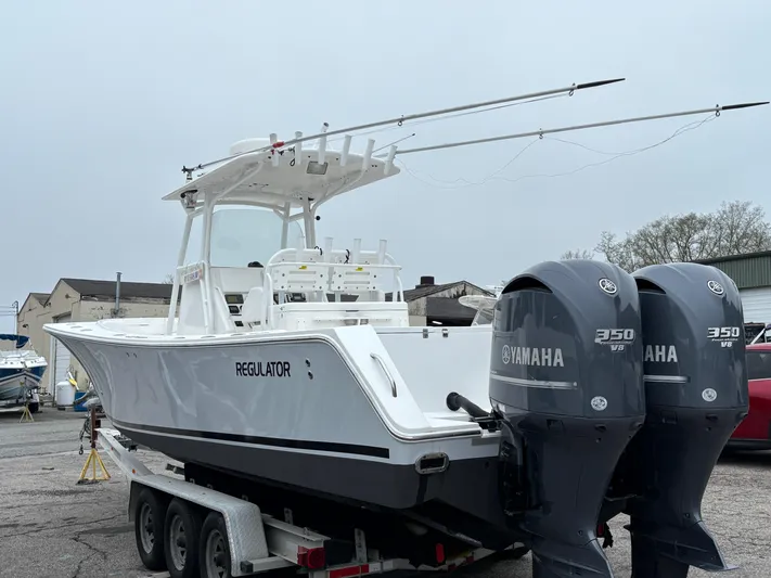  Yacht Photos Pics 2009 Regulator 32 Forward Seating boat with twin Yamaha 350 engines on a trailer.