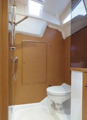 Tharos Yacht Photos Pics 2016 Jeanneau 379 yacht bathroom with modern fixtures and wooden accents.