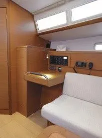 Tharos Yacht Photos Pics Interior of 2016 Jeanneau 379 sailboat with navigation station and seating area.