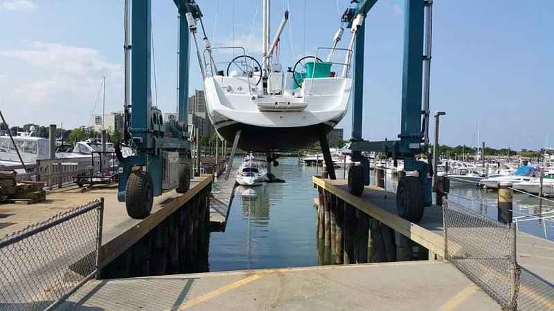 Tharos Yacht Photos Pics Jeanneau 379 sailboat being lifted at a marina, 2016 model.