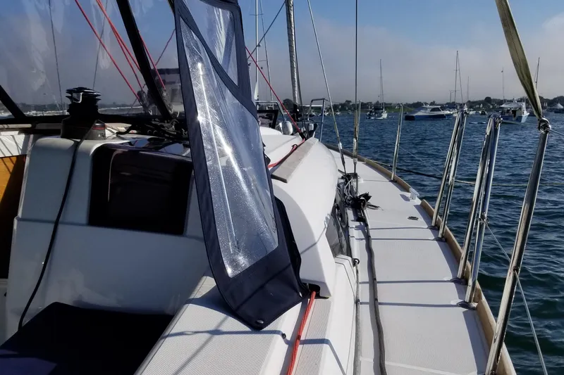 Tharos Yacht Photos Pics 2016 Jeanneau 379 sailboat deck with marina view in the background.