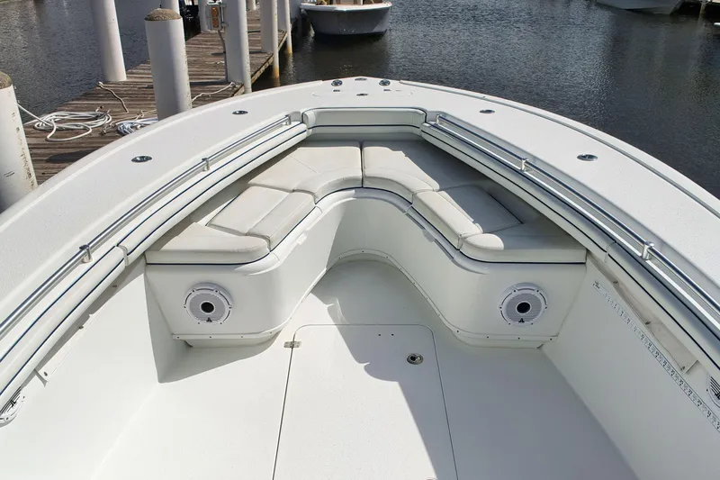  Yacht Photos Pics 2017 Yellowfin 32 Offshore boat with cushioned seating at the bow, docked by the water.