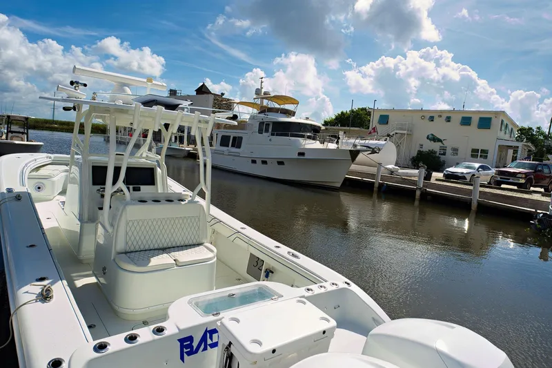 Yacht Photos Pics 2017 Yellowfin 32 Offshore boat docked near a marina with other vessels.