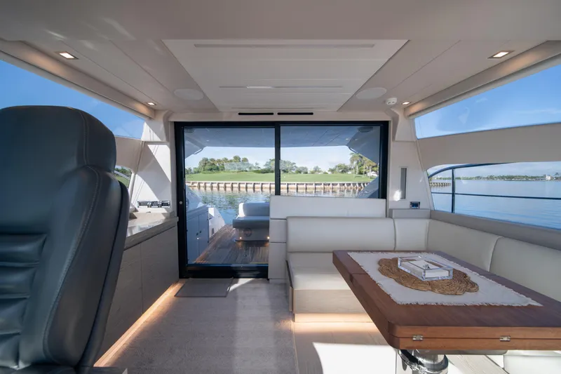 Juice Yacht Photos Pics Luxurious interior of 2019 Filippetti S55 yacht with elegant seating and scenic water view.