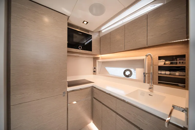 Juice Yacht Photos Pics Luxurious 2019 Filippetti S55 yacht kitchen with modern cabinetry and sleek design.