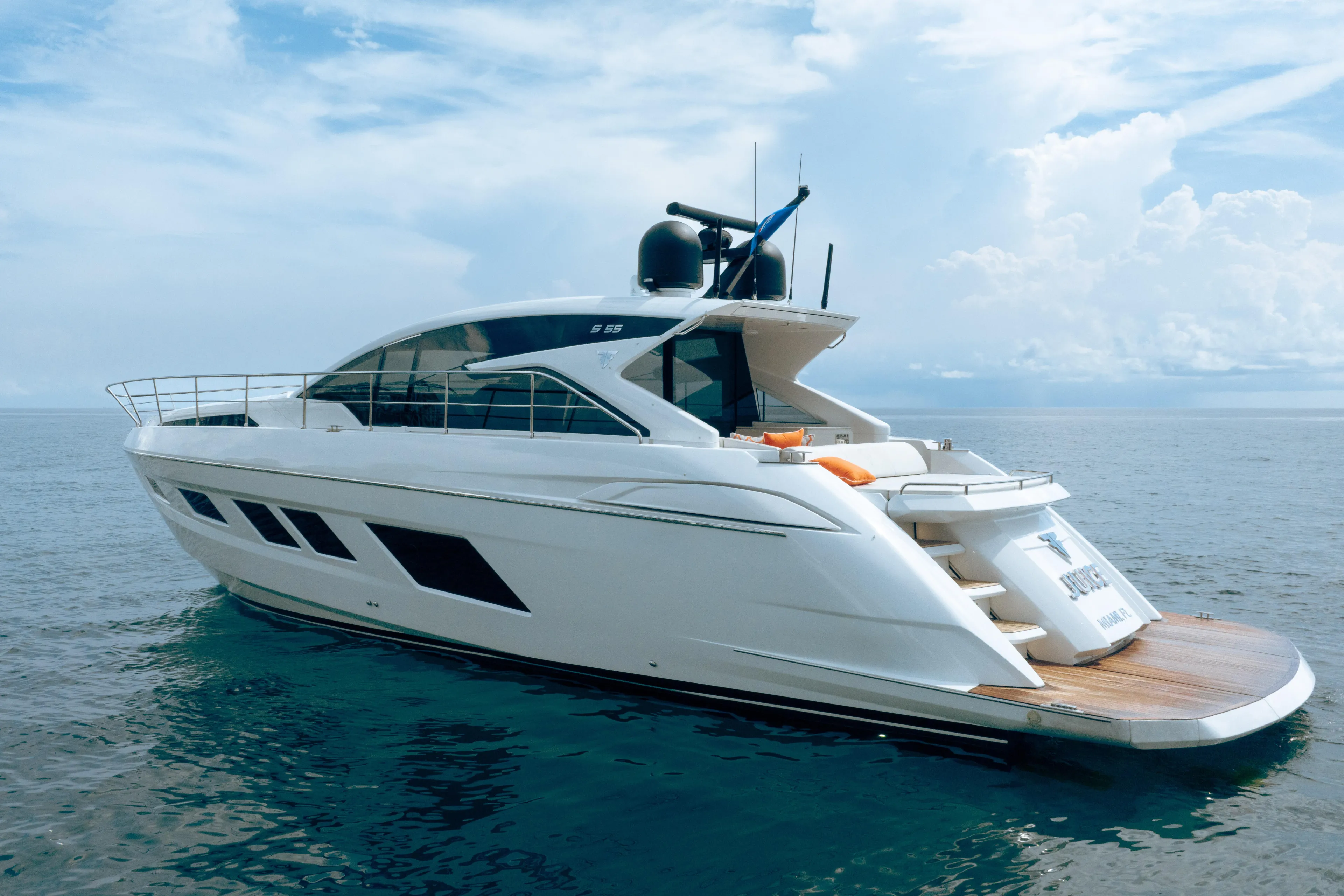 Juice Yacht Photos Pics 2019 Filippetti S55 yacht on calm ocean waters under a partly cloudy sky.