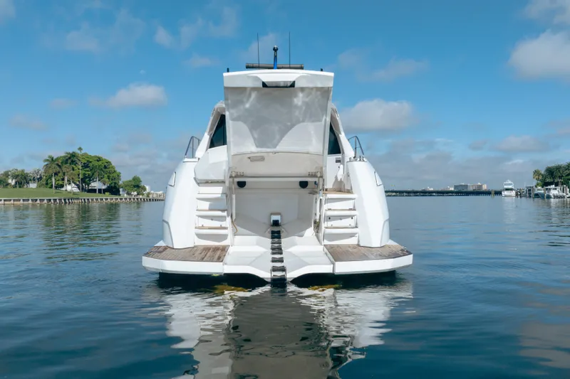 Juice Yacht Photos Pics 2019 Filippetti S55 yacht on calm water, rear view with open deck.