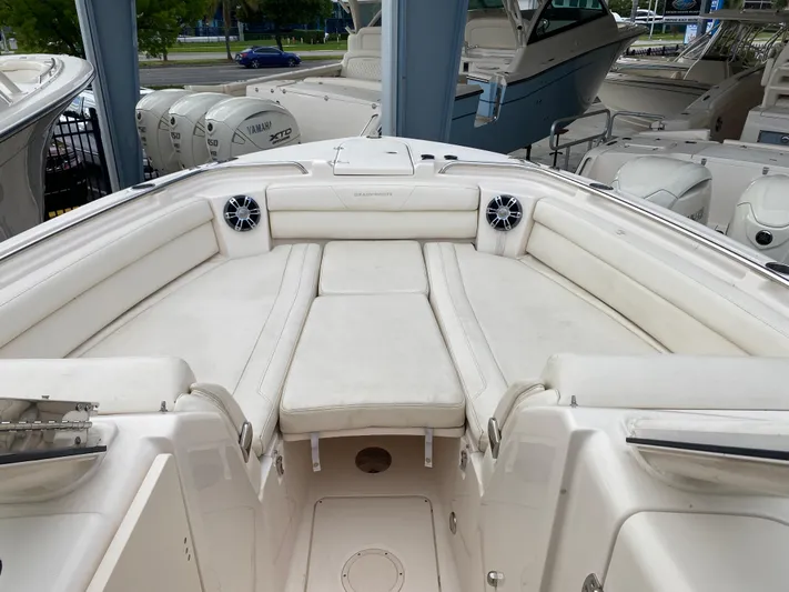  Yacht Photos Pics 2022 Grady-White Freedom 325 boat interior with white cushioned seating and speakers.