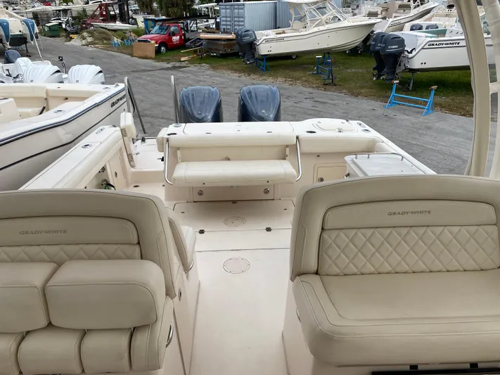  Yacht Photos Pics 2022 Grady-White Freedom 325 boat interior with dual engines and cushioned seating.