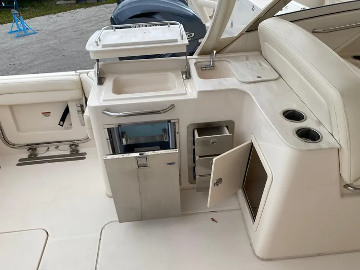  Yacht Photos Pics 2022 Grady-White Freedom 325 boat interior with sink, storage, and seating area.
