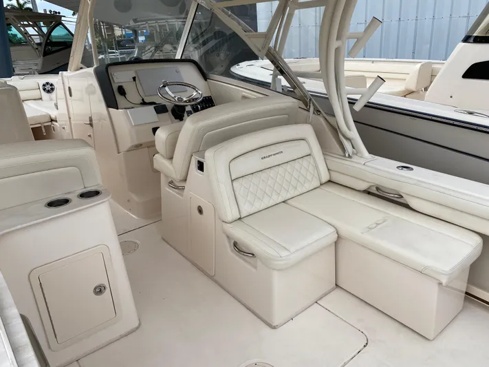  Yacht Photos Pics 2022 Grady-White Freedom 325 boat interior with luxurious seating and helm station.