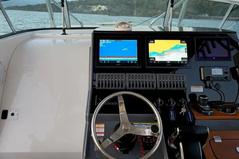  Yacht Photos Pics 2024 Victory V400 Open Sea boat dashboard with navigation screens and steering wheel.