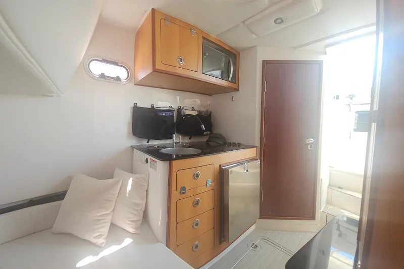  Yacht Photos Pics Interior of 2024 Victory Yachts V400 Open Sea, featuring kitchenette and seating area.