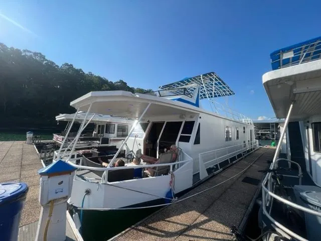  Yacht Photos Pics 1988 Stardust Cruisers houseboat docked at a marina on a sunny day.
