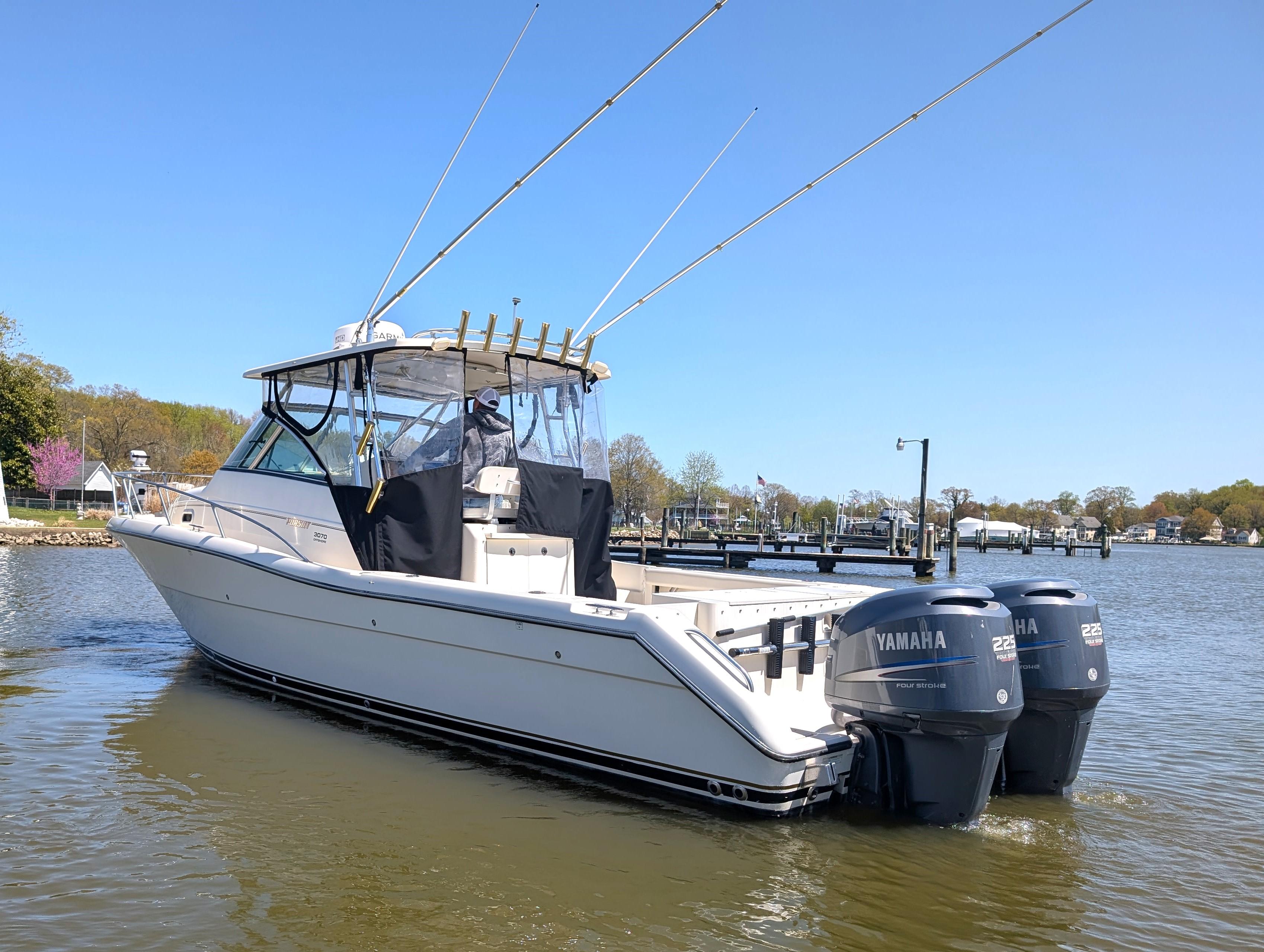 2001 Pursuit 3070 Offshore Center Console boat with dual Yamaha engines on calm water.