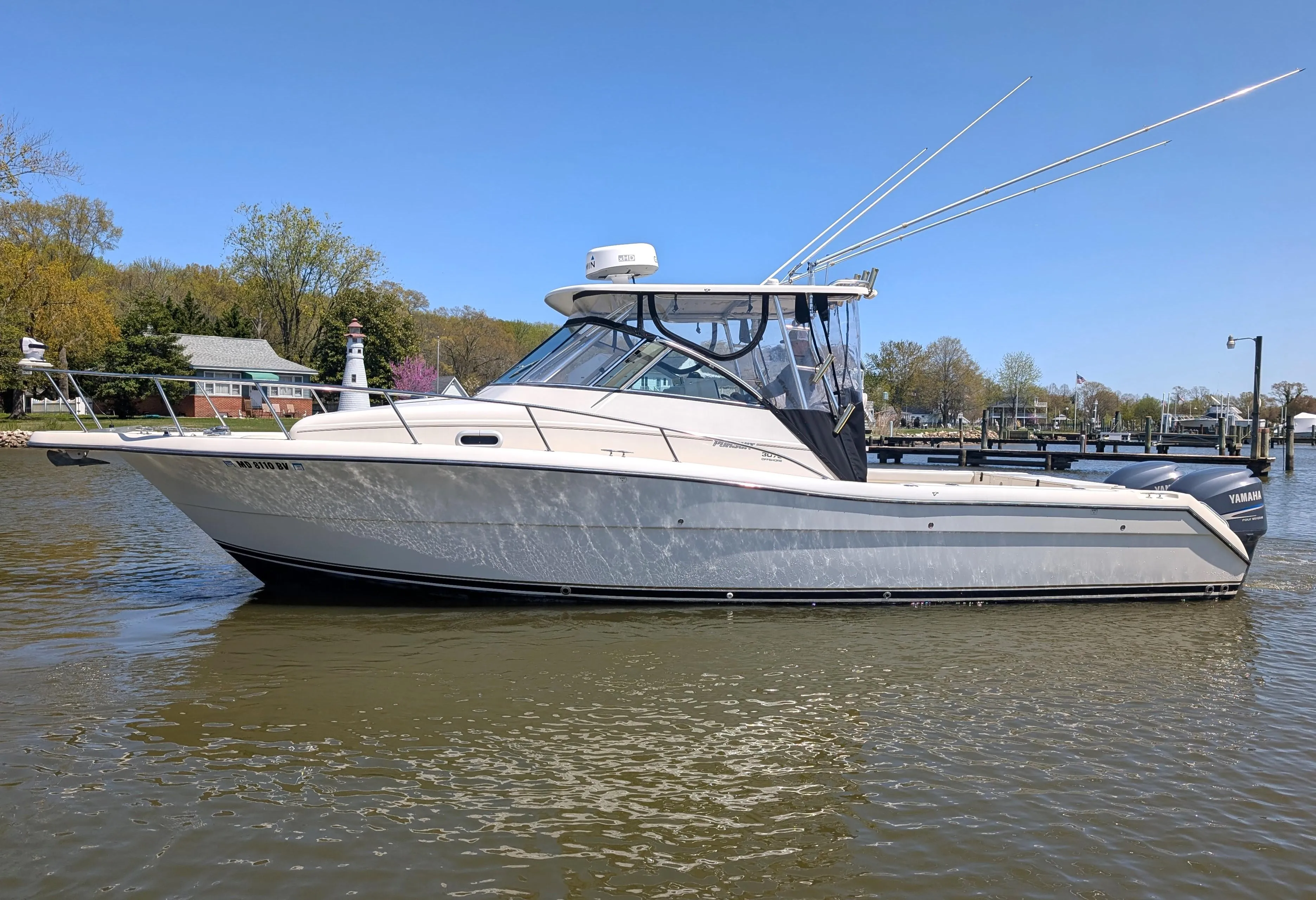 2001 Pursuit 3070 Offshore Center Console boat on calm water, side view.