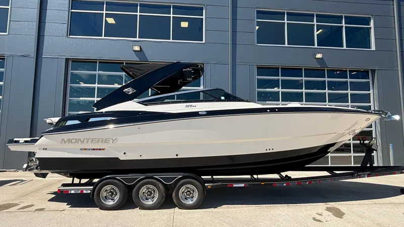  Yacht Photos Pics 2014 Monterey 328 Super Sport boat on trailer, parked outside a modern building.