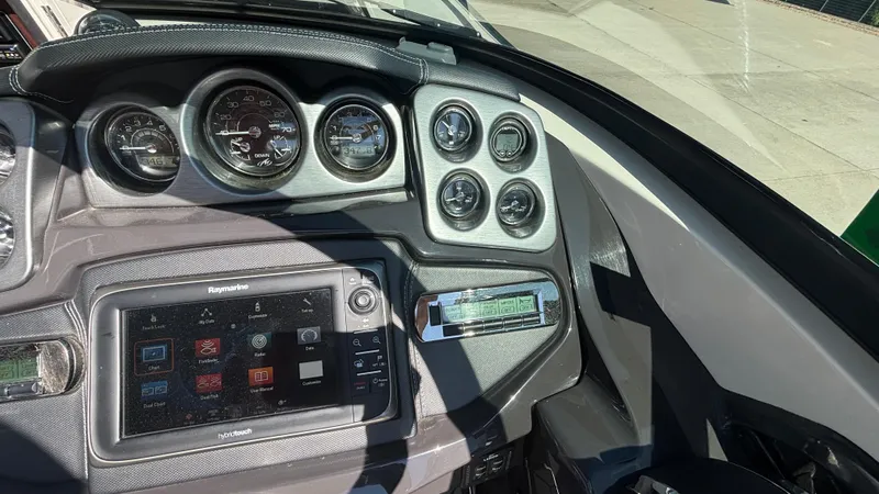  Yacht Photos Pics Dashboard of a 2014 Monterey 328 Super Sport boat with gauges and navigation system.