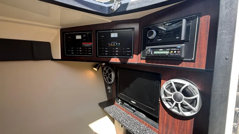  Yacht Photos Pics Interior of 2014 Monterey 328 Super Sport with control panels and audio system.