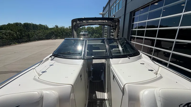  Yacht Photos Pics 2014 Monterey 328 Super Sport boat docked near a modern building.