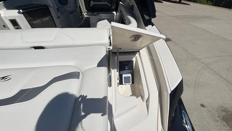  Yacht Photos Pics 2014 Monterey 328 Super Sport boat interior with open storage compartment on deck.