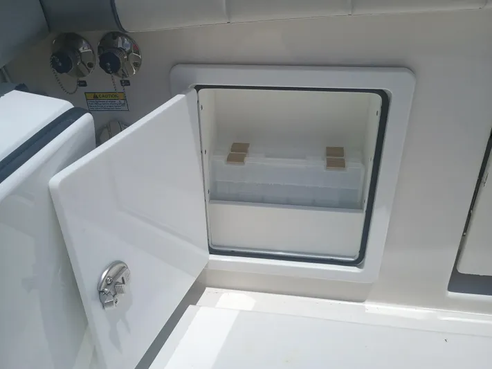 41-083 Yacht Photos Pics Open storage compartment on 2023 Regulator 41 boat, featuring a white interior and secure latch.