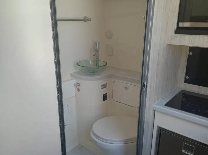 41-083 Yacht Photos Pics 2023 Regulator 41 boat bathroom with modern sink and compact design.