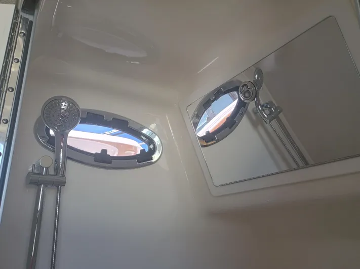 41-083 Yacht Photos Pics Interior of 2023 Regulator 41 boat shower with porthole and showerhead.