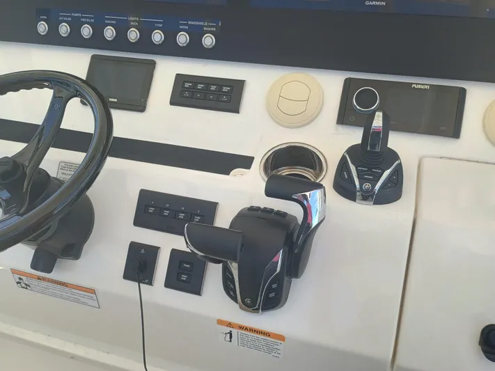 41-083 Yacht Photos Pics Control panel of a 2023 Regulator 41 boat with steering wheel and throttle controls.