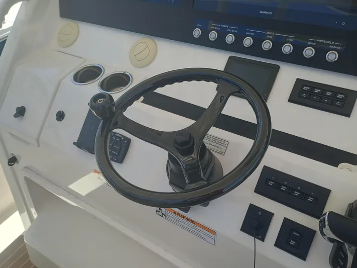 41-083 Yacht Photos Pics 2023 Regulator 41 boat helm with steering wheel and control panel.