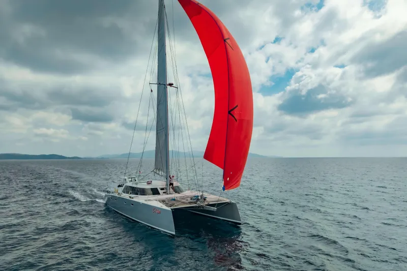 Gizmo Yacht Photos Pics Sailing catamaran Morrelli & Melvin 65 custom, 2012, with red sail on open sea.