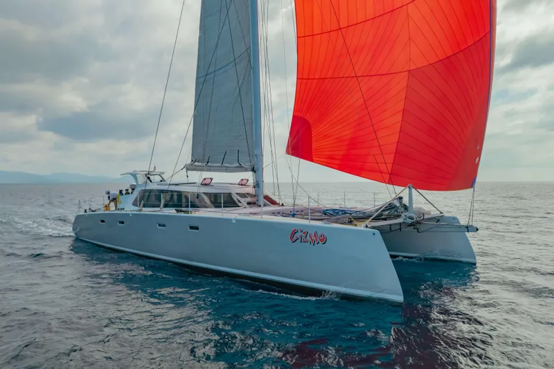 Gizmo Yacht Photos Pics Sailing catamaran "Gizmo" by Morrelli & Melvin, 65 custom, 2012, with vibrant red sail.