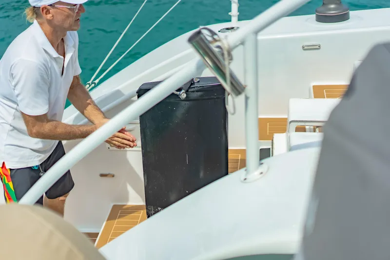 Gizmo Yacht Photos Pics Man on Morrelli & Melvin 65 custom yacht, 2012, adjusting equipment on deck.