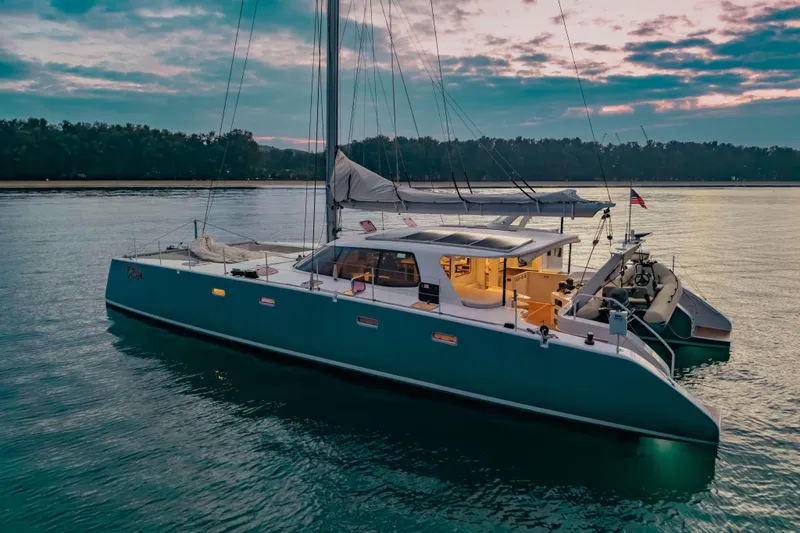 Gizmo Yacht Photos Pics Luxurious 2012 Morrelli & Melvin 65 custom yacht at sunset on tranquil waters.