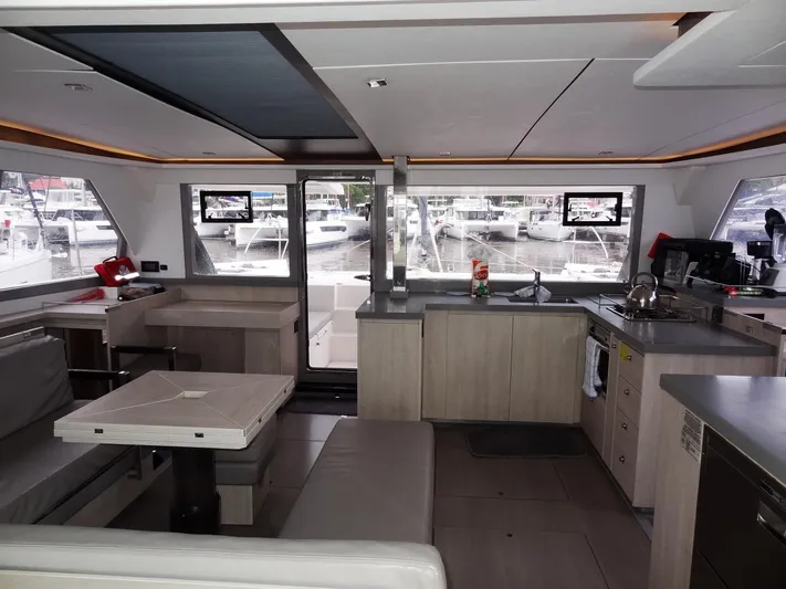 Meow Or Never Yacht Photos Pics Modern interior of 2020 Leopard 45 catamaran with kitchen and dining area.