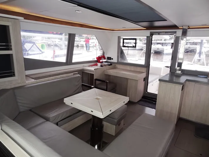 Meow Or Never Yacht Photos Pics Modern interior of 2020 Leopard 45 yacht with spacious seating and large windows.
