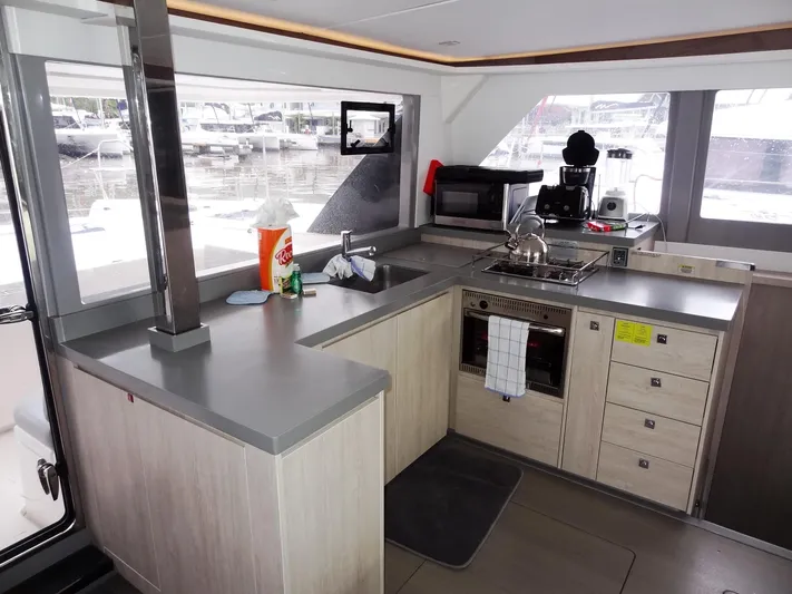 Meow Or Never Yacht Photos Pics Modern kitchen interior on 2020 Leopard 45 catamaran with appliances and marina view.