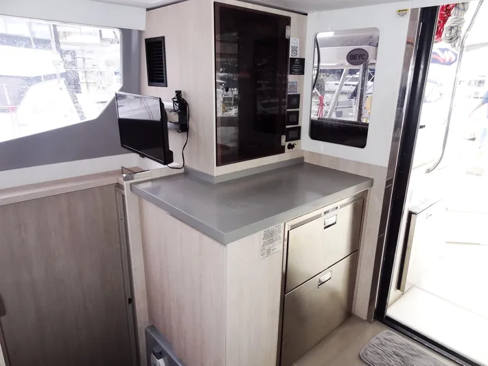 Meow Or Never Yacht Photos Pics Modern kitchen area in a 2020 Leopard 45 catamaran, featuring sleek cabinetry and appliances.