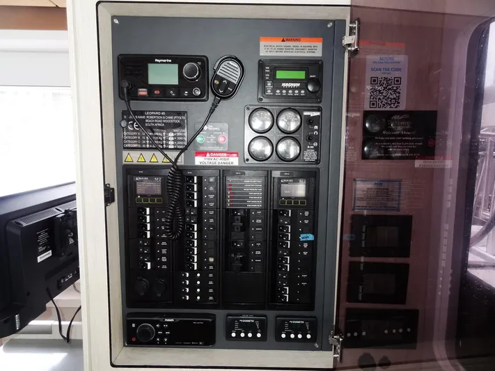 Meow Or Never Yacht Photos Pics Electrical control panel on a 2020 Leopard 45 yacht, featuring various switches and communication devices.