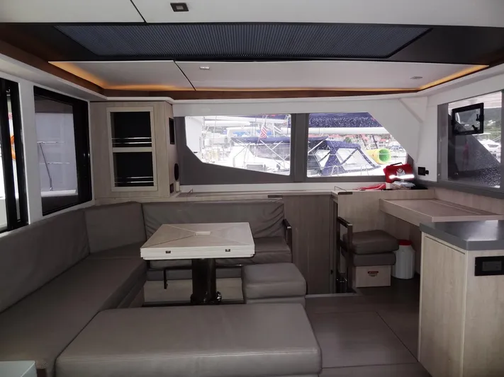 Meow Or Never Yacht Photos Pics Modern interior of 2020 Leopard 45 yacht with spacious seating and large windows.